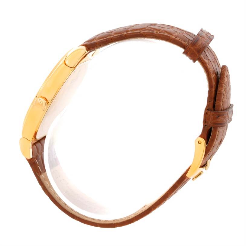 The image shows a side view of a Rolex Cellini 5330 Men's Yellow Gold White Dial 5330 Men's Yellow Gold White Dial watch, highlighting its gold case, crown, and brown leather strap with a buckle.