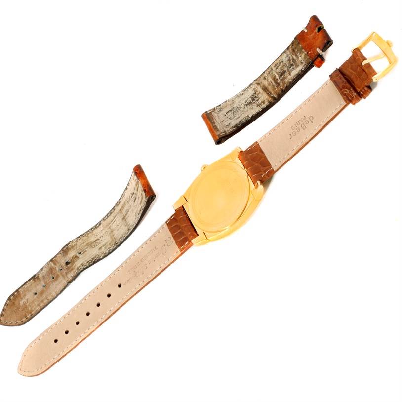 The image shows the back view of a Rolex Cellini 5330 Men's Yellow Gold White Dial 5330 Men's Yellow Gold White Dial watch with detached leather straps.