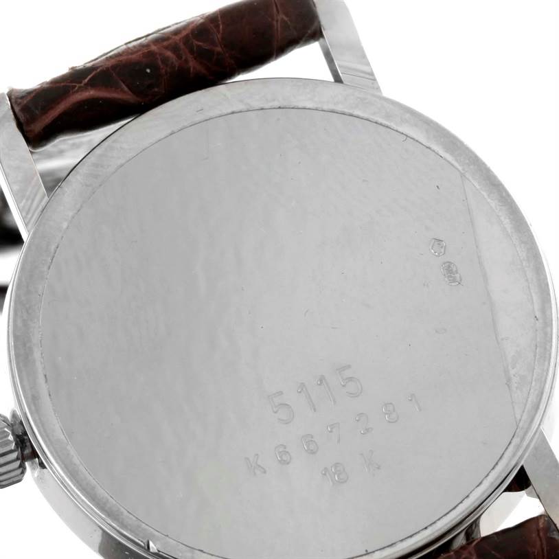 The image shows the back of a Rolex Cellini 5115 Men's White Gold Silver Dial 5115 Men's White Gold Silver Dial watch case, including the crown, strap, and engraved model details.