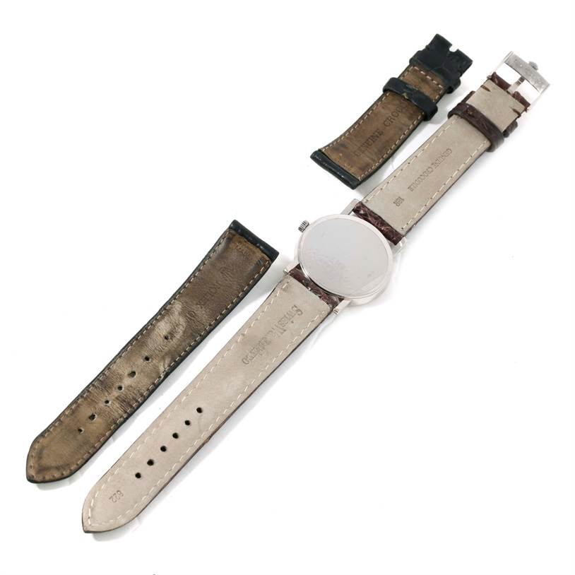 The image shows a Rolex Cellini 5115 Men's White Gold Silver Dial 5115 Men's White Gold Silver Dial watch from the back with detached leather straps.