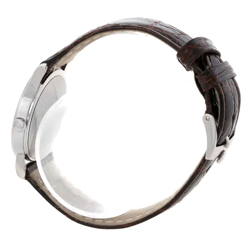 This image shows a side view of the Cellini model by Rolex, highlighting the case, crown, and leather strap.