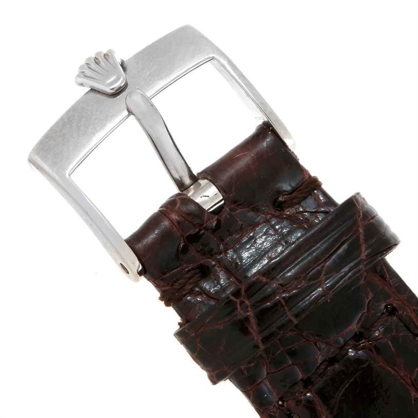 This image shows a close-up of the buckle and part of the leather strap of a Rolex Cellini 5115 Men's White Gold Silver Dial 5115 Men's White Gold Silver Dial watch.