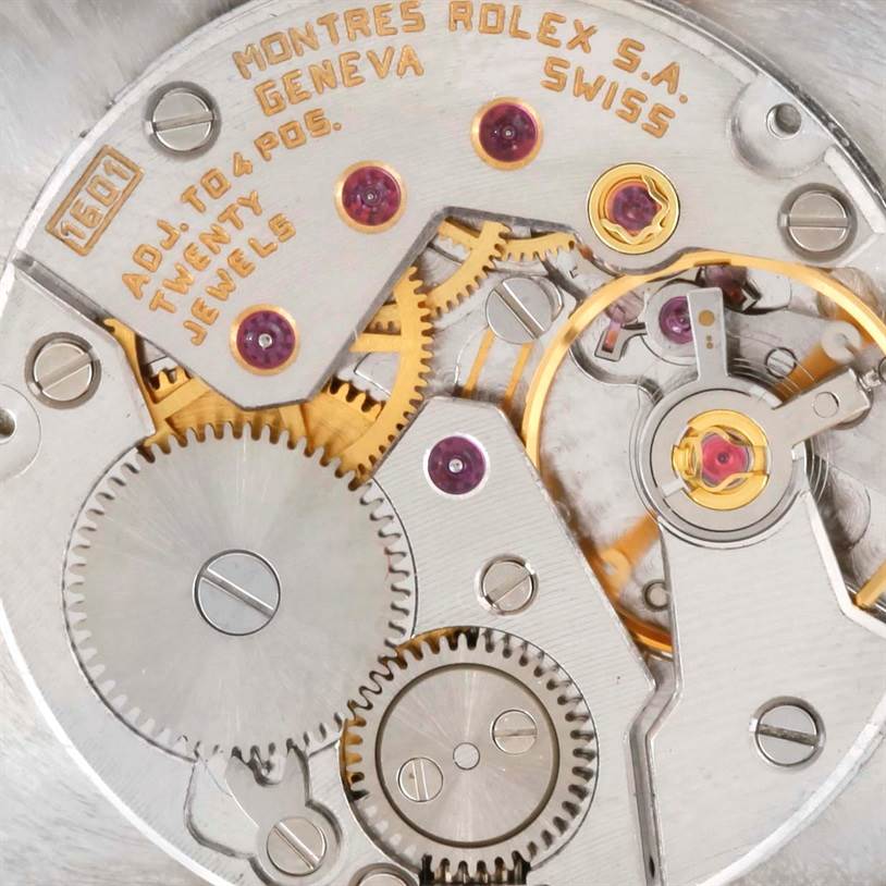 The image shows a close-up of the movement mechanism inside a Rolex Cellini 5071 Men's Yellow Gold Champagne Dial 5071 Men's Yellow Gold Champagne Dial watch, highlighting gears, jewels, and engravings.