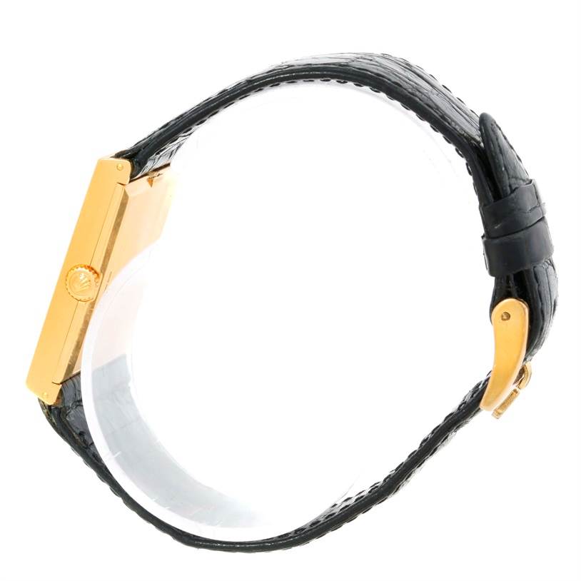 This Rolex Cellini 5071 Men's Yellow Gold Champagne Dial 5071 Men's Yellow Gold Champagne Dial watch is shown from a side angle, displaying the gold crown, case, and black leather strap.