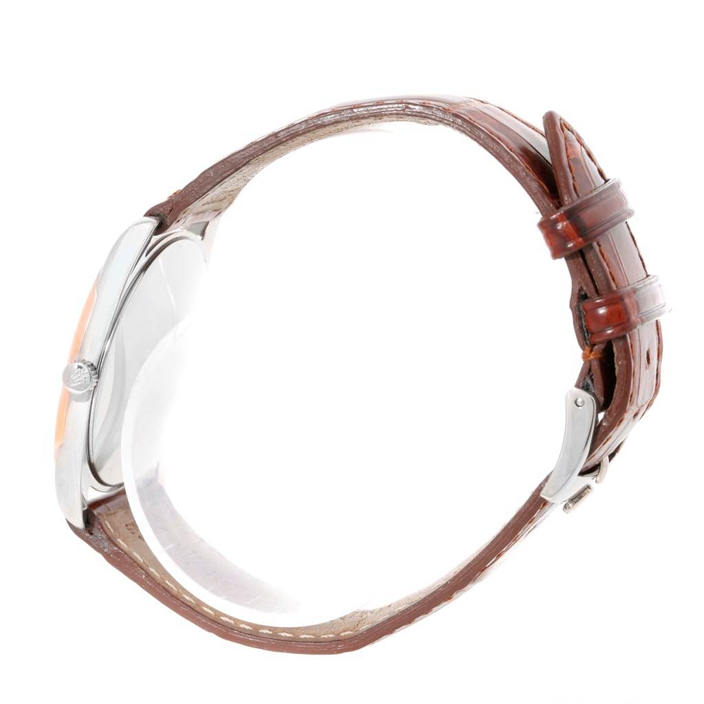 The image shows a Rolex Cellini 4233 Men's White Gold Black Dial 4233 Men's White Gold Black Dial model watch from a side view, highlighting its leather strap and case.