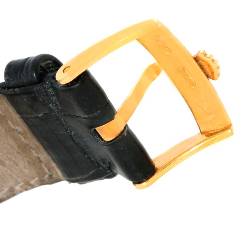 This image shows a close-up of the gold buckle and black leather strap from a Rolex Cellini 5115 Men
s Yellow Gold Mother of Pearl Dial 5115 Men
s Yellow Gold Mother of Pearl Dial watch.