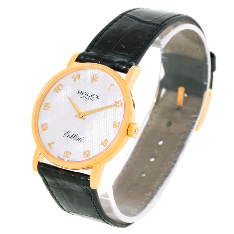 The image shows a Rolex Cellini 5115 Men
s Yellow Gold Mother of Pearl Dial 5115 Men
s Yellow Gold Mother of Pearl Dial watch captured at an angle highlighting its face, gold casing, and black leather strap.