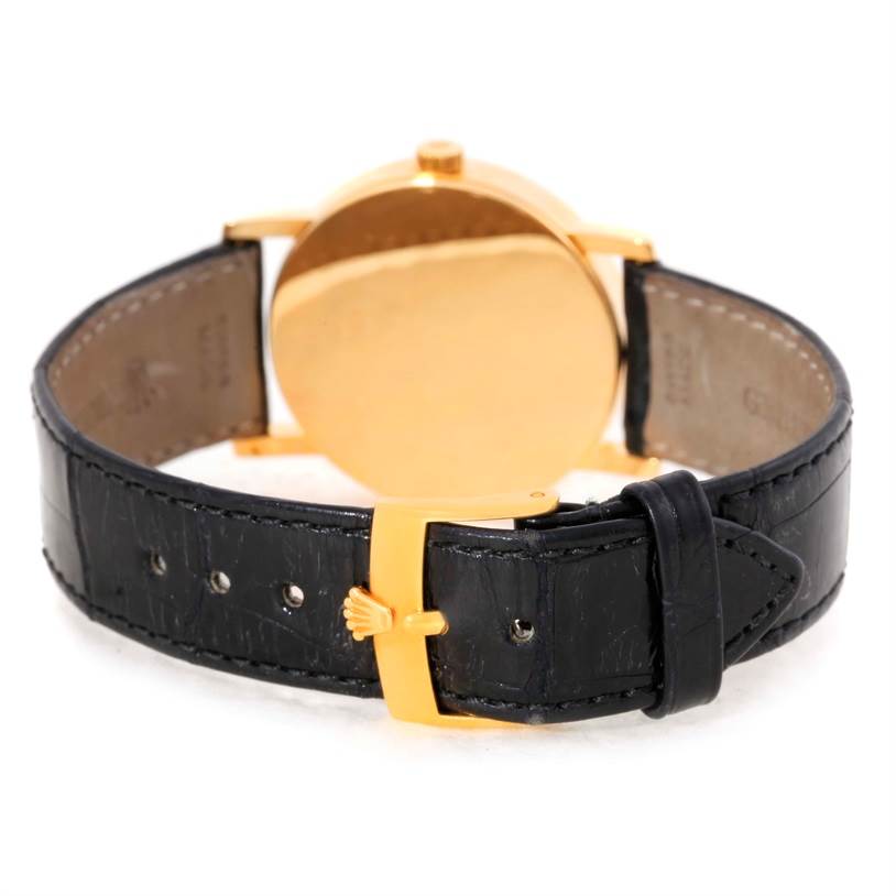 This image shows the rear view of a Rolex Cellini 5115 Men
s Yellow Gold Mother of Pearl Dial 5115 Men
s Yellow Gold Mother of Pearl Dial watch, highlighting its case back and black leather strap with a gold buckle.