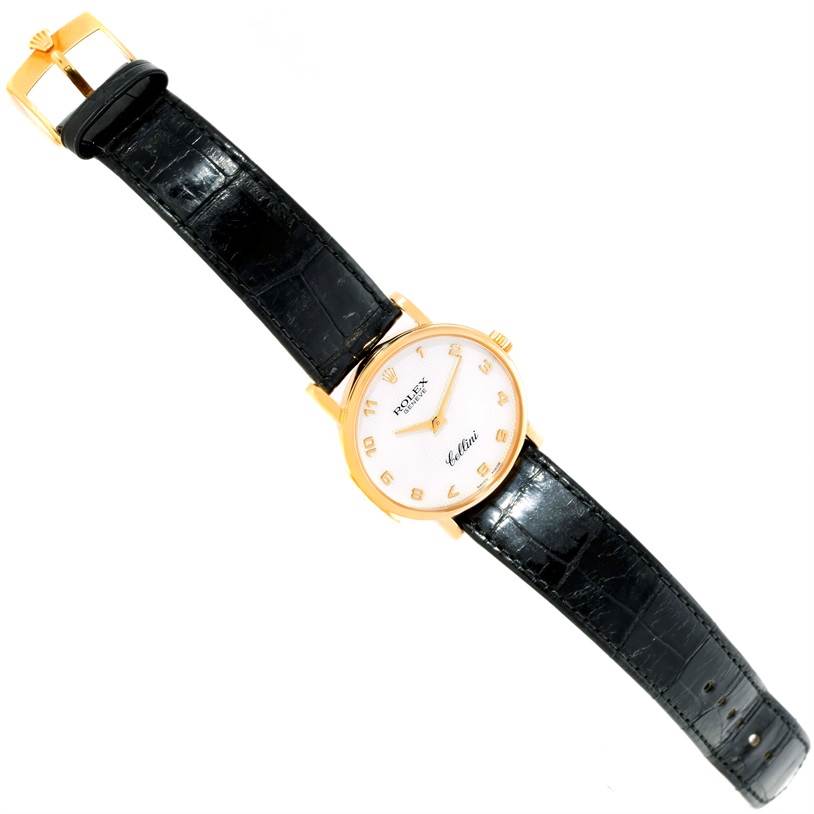 The Rolex Cellini 5115 Men
s Yellow Gold Mother of Pearl Dial 5115 Men
s Yellow Gold Mother of Pearl Dial watch is shown from a top-down angle displaying the face, case, and leather band.