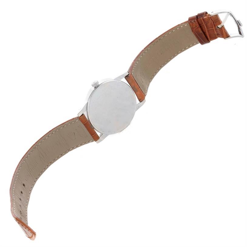 This Rolex Cellini 5116 Men's White Gold Silver Dial 5116 Men's White Gold Silver Dial watch is shown from the back, displaying its silver case and brown leather strap with the buckle.