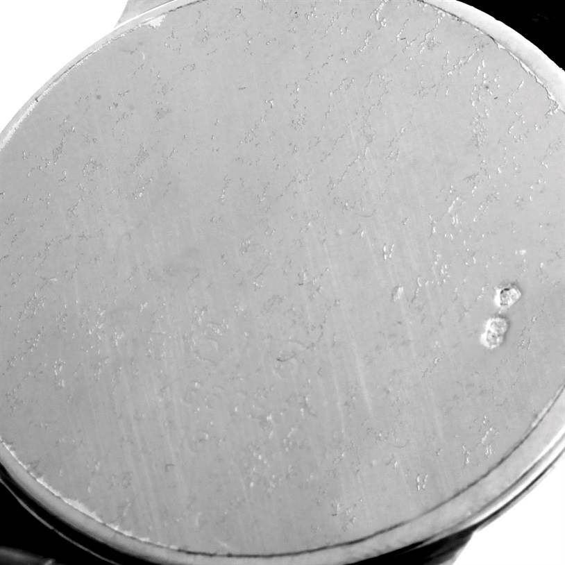 The image shows a close-up of the case back of a Rolex Cellini 5116 Men's White Gold Silver Dial 5116 Men's White Gold Silver Dial watch, displayed at an angle.