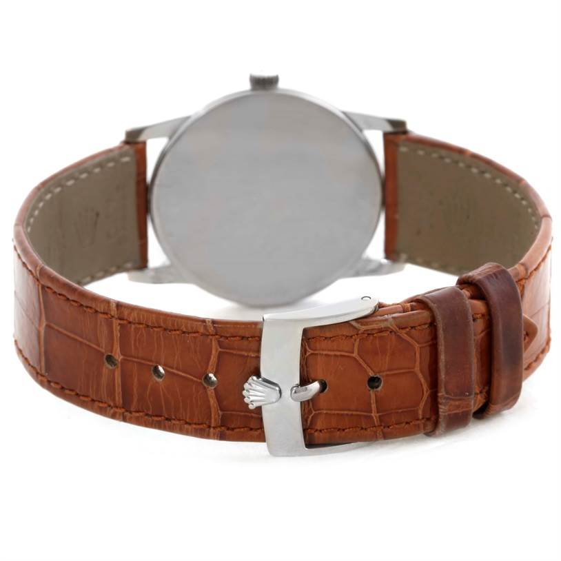 The image shows the back view of the Rolex Cellini 5116 Men's White Gold Silver Dial 5116 Men's White Gold Silver Dial watch, highlighting its brown leather strap and metal clasp.