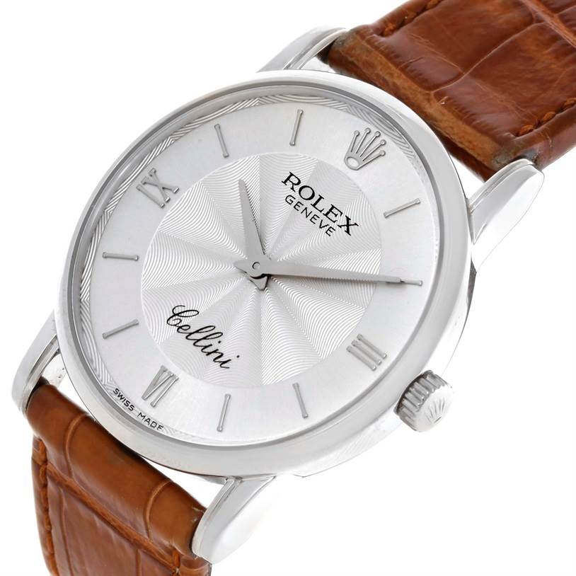 The image shows the face of a Rolex Cellini 5116 Men's White Gold Silver Dial 5116 Men's White Gold Silver Dial watch, with a silver dial, Roman numerals, and a brown leather strap, captured at a slight angle.
