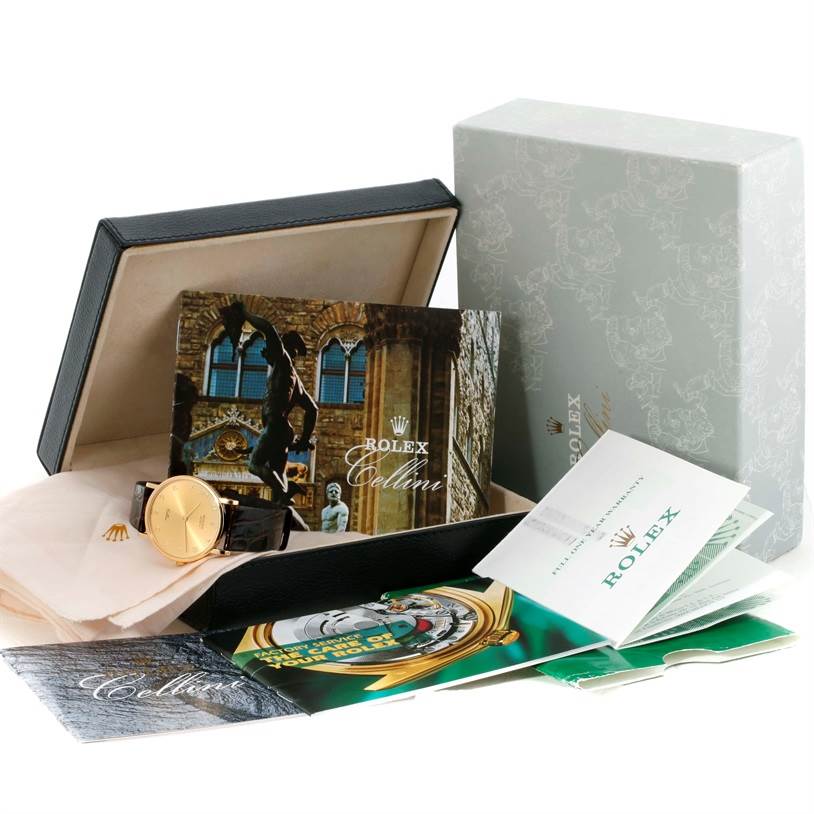 The image shows a Rolex Cellini 5112 Men
s Yellow Gold Champagne Dial 5112 Men
s Yellow Gold Champagne Dial watch at an angled view, featuring its box, booklets, and packaging.