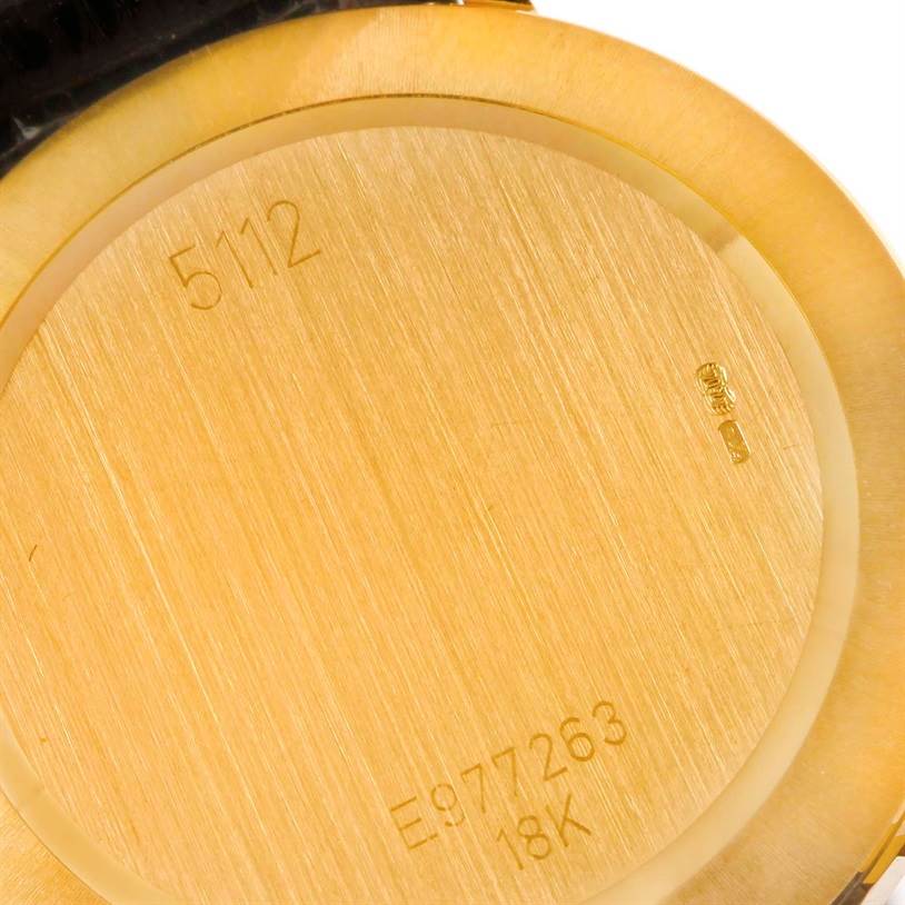 The image shows the engraved case back of a Rolex Cellini 5112 Men's Yellow Gold Beige Dial 5112 Men's Yellow Gold Beige Dial watch, highlighting the model number and gold purity marks.