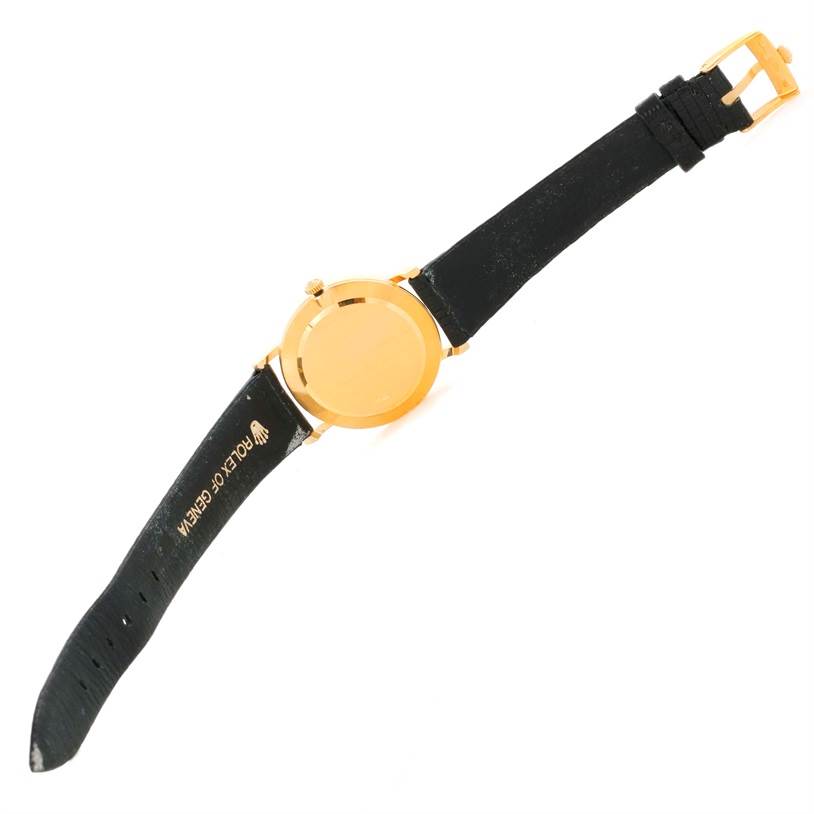 The image shows the back of the Rolex Cellini 5112 Men's Yellow Gold Beige Dial 5112 Men's Yellow Gold Beige Dial watch and its black leather strap, along with the gold buckle.