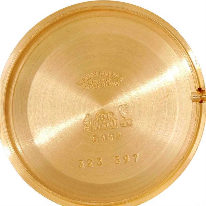 This image shows the inner side of the back case of a Rolex Cellini 5112 Men's Yellow Gold Beige Dial 5112 Men's Yellow Gold Beige Dial watch, displaying engravings and hallmark stamps.