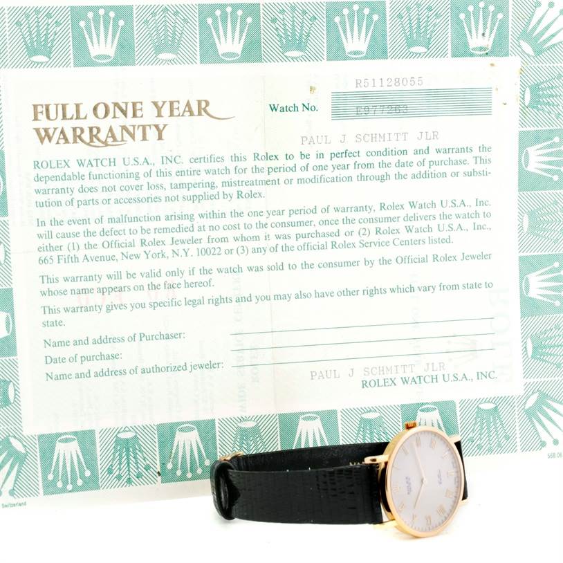 The Rolex Cellini 5112 Men's Yellow Gold Beige Dial 5112 Men's Yellow Gold Beige Dial watch is shown from a side angle along with its full one-year warranty card.