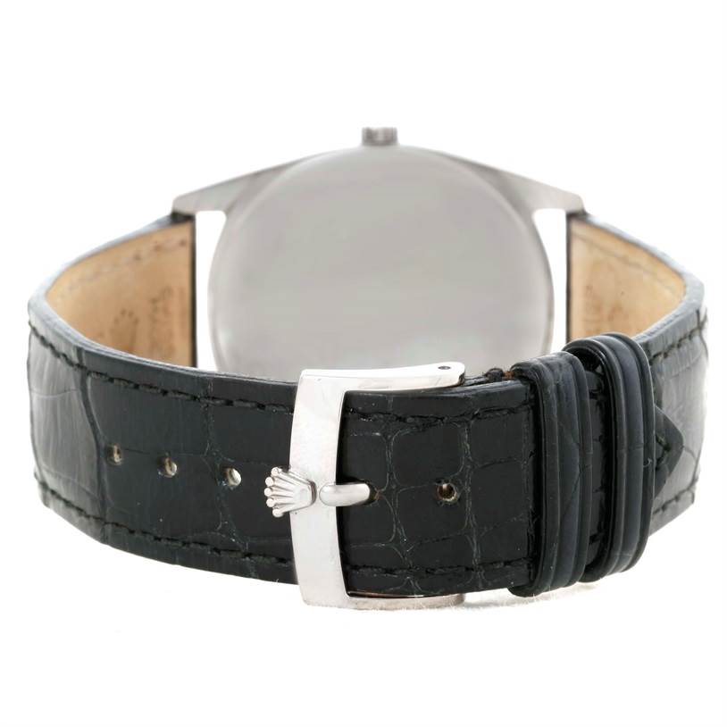 This image shows the back of a Rolex Cellini 4233 Men's White Gold Black Dial 4233 Men's White Gold Black Dial watch and its leather strap with the buckle.