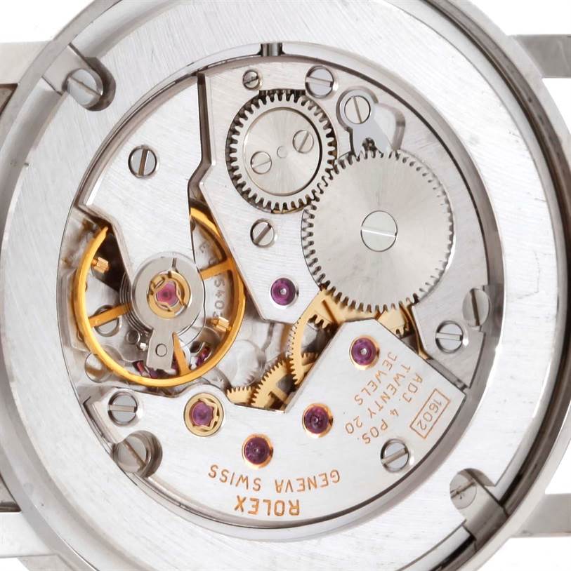 This image shows a close-up view of the Rolex Cellini 5115 Men's White Gold Silver Dial 5115 Men's White Gold Silver Dial watch's intricate internal movement, displaying gears, jewels, and the Rolex branding.