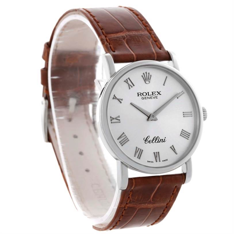 The image shows a Rolex Cellini 5115 Men's White Gold Silver Dial 5115 Men's White Gold Silver Dial watch, highlighting its dial, Roman numerals, and brown leather strap from a side angle.