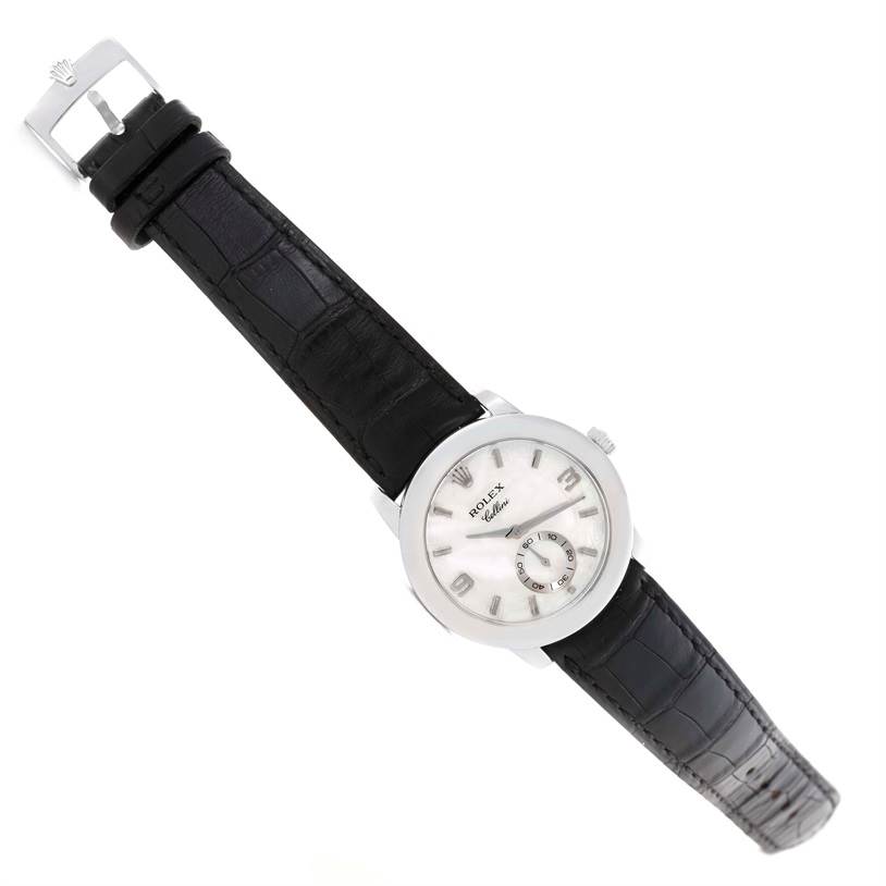 The Rolex Cellini 5240 Men's Platinum Mother of Pearl Dial 5240 Men's Platinum Mother of Pearl Dial watch is shown from an angled top view, displaying the dial, case, and black leather strap with a clasp.