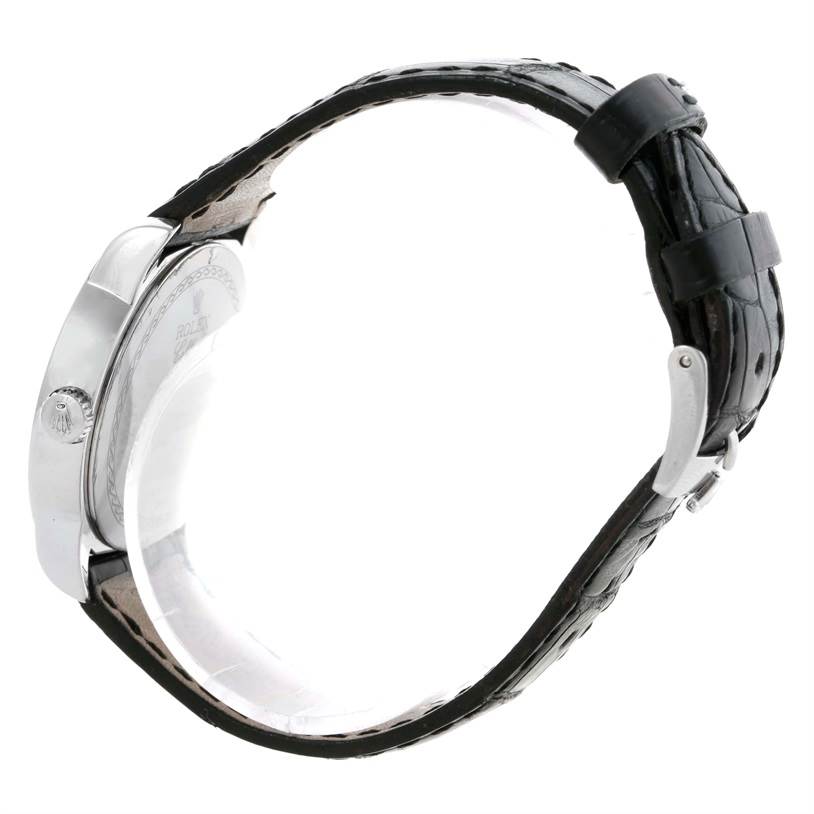 A side view of a Rolex Cellini 5240 Men's Platinum Mother of Pearl Dial 5240 Men's Platinum Mother of Pearl Dial watch, displaying its case, crown, and black leather strap with buckle.