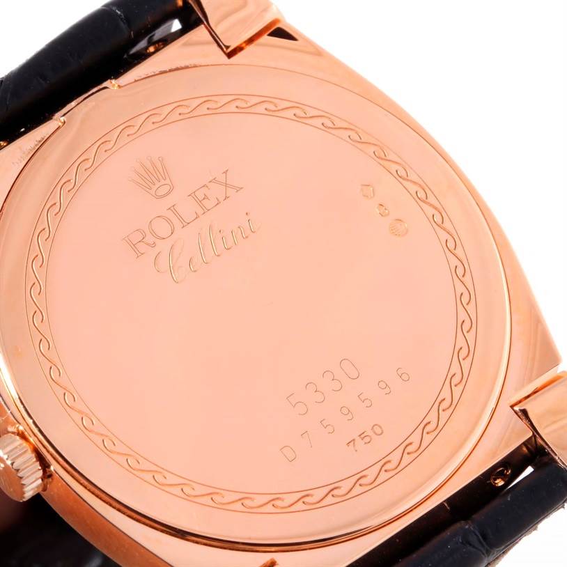 The image depicts the back case of a Rolex Cellini 5330 Men's Rose Gold Grey Dial 5330 Men's Rose Gold Grey Dial watch in a close-up angle, showcasing its engravings and serial number.