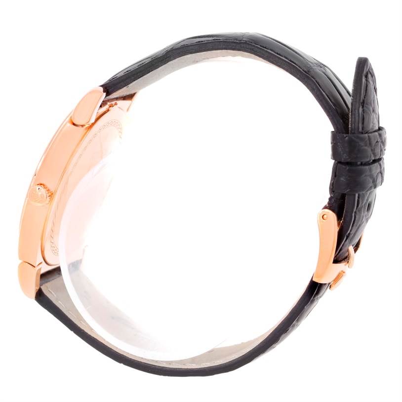 This side profile of the Rolex Cellini 5330 Men's Rose Gold Grey Dial 5330 Men's Rose Gold Grey Dial watch shows the rose gold case, crown, and black leather strap with a gold buckle.