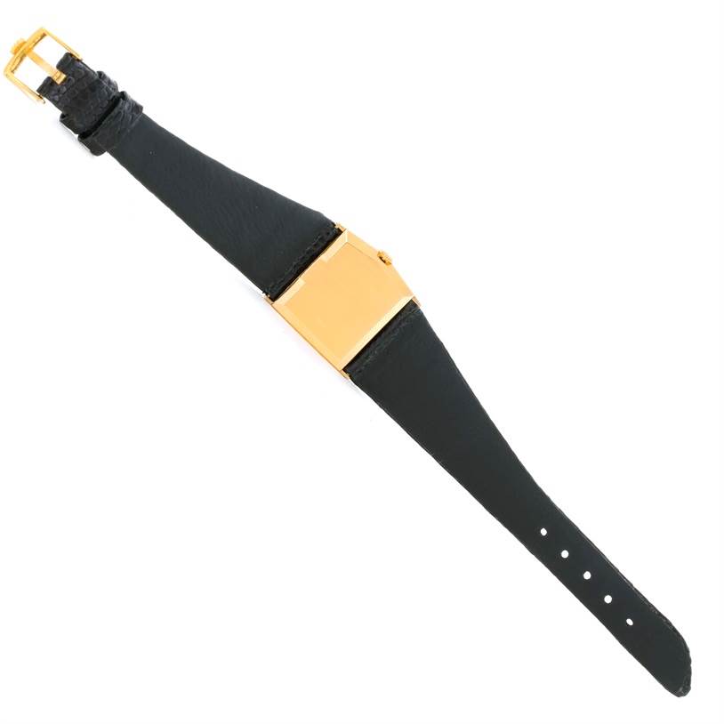 This image shows a top view of the Rolex Cellini 4153 Men's Yellow Gold Black Dial 4153 Men's Yellow Gold Black Dial watch focusing on its black leather strap and rectangular gold case.