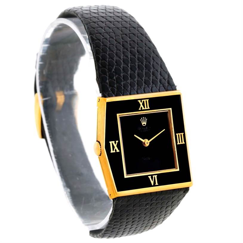 The image shows a Rolex Cellini 4153 Men's Yellow Gold Black Dial 4153 Men's Yellow Gold Black Dial watch from a slightly tilted side view, featuring its black leather strap and a rectangular black and gold face.
