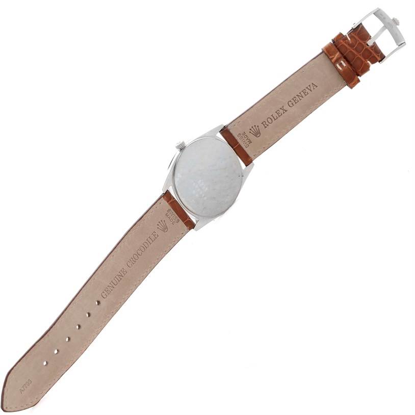 The image shows the back view of a Rolex Cellini 4233 Men's White Gold Black Dial 4233 Men's White Gold Black Dial watch, showcasing its genuine crocodile strap and buckle.