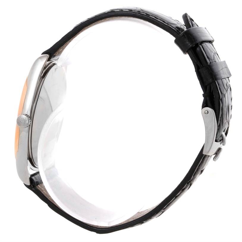 This image shows a side view of the Rolex Cellini 4233 Men's White Gold White Dial 4233 Men's White Gold White Dial watch, highlighting its case, crown, and a black leather strap with a clasp.