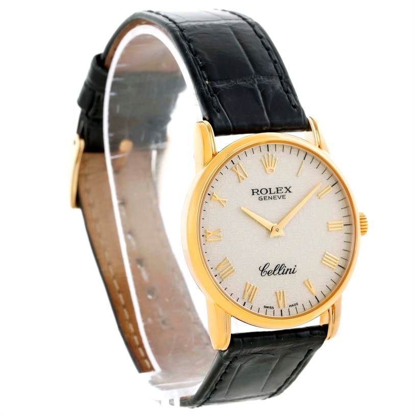 This image shows a side angle of a Rolex Cellini 5116 Men's Yellow Gold Beige Dial 5116 Men's Yellow Gold Beige Dial watch featuring its round face, gold-tone case, and black leather strap.