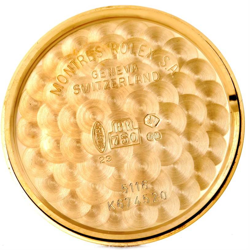 This image shows the inside of the case back for a Rolex Cellini 5116 Men's Yellow Gold Beige Dial 5116 Men's Yellow Gold Beige Dial model, displaying hallmarks and the brand's engravings.