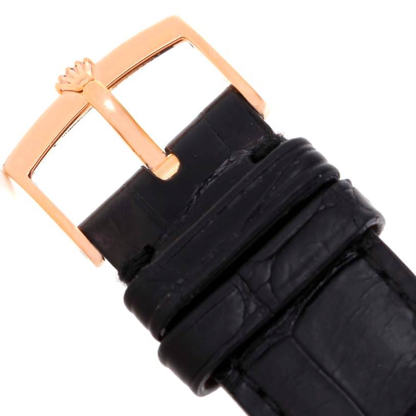 The image shows the buckle of a Rolex Cellini 5330 Men's Rose Gold Grey Dial 5330 Men's Rose Gold Grey Dial watch strap, featuring a gold clasp and black leather band.