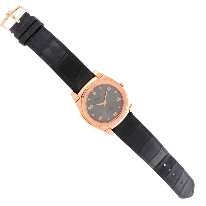 The image shows a top view of a Rolex Cellini 5330 Men's Rose Gold Grey Dial 5330 Men's Rose Gold Grey Dial watch with a black leather strap and a rose gold case.
