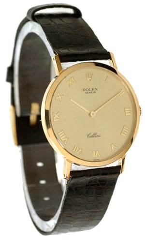 The Rolex Cellini 4112 Men's Yellow Gold Champagne Dial 4112 Men's Yellow Gold Champagne Dial watch is shown at an angle displaying its gold case, Roman numeral dial, and black leather strap.