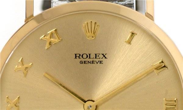 This image shows a close-up of the dial of a Rolex Cellini 4112 Men's Yellow Gold Champagne Dial 4112 Men's Yellow Gold Champagne Dial watch, highlighting its gold hands and Roman numeral markers.