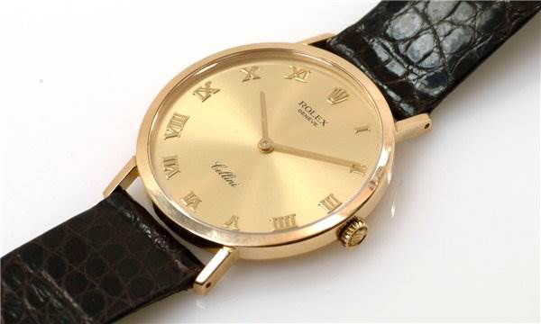 The image shows a Rolex Cellini 4112 Men's Yellow Gold Champagne Dial 4112 Men's Yellow Gold Champagne Dial watch angled to display its gold dial, Roman numerals, and black leather strap.