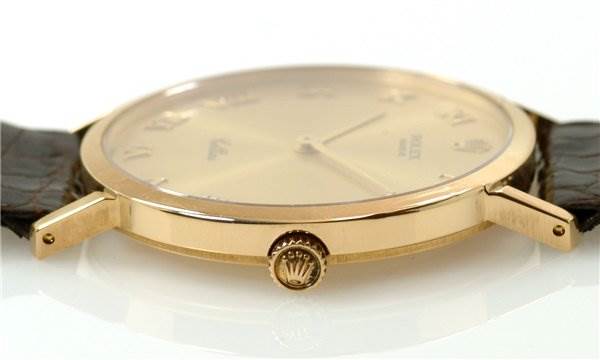 The image shows a side view of the Rolex Cellini 4112 Men's Yellow Gold Champagne Dial 4112 Men's Yellow Gold Champagne Dial watch, highlighting the gold case, crown, and a leather strap.