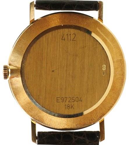 The image shows the back case of a Rolex Cellini 4112 Men's Yellow Gold Champagne Dial 4112 Men's Yellow Gold Champagne Dial model watch, including the crown, serial number, and straps in the top and bottom positions.