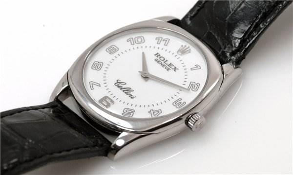The Rolex Cellini 4233/9 Men's White Gold White Dial 4233/9 Men's White Gold White Dial watch is shown at a slight angle, displaying the face, crown, case, and part of the leather strap.