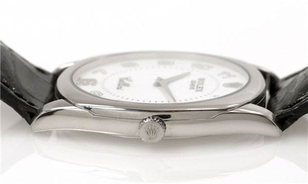 The image shows a side view of the Rolex Cellini 4233/9 Men's White Gold White Dial 4233/9 Men's White Gold White Dial watch, highlighting the crown and part of the watch case with the leather strap.