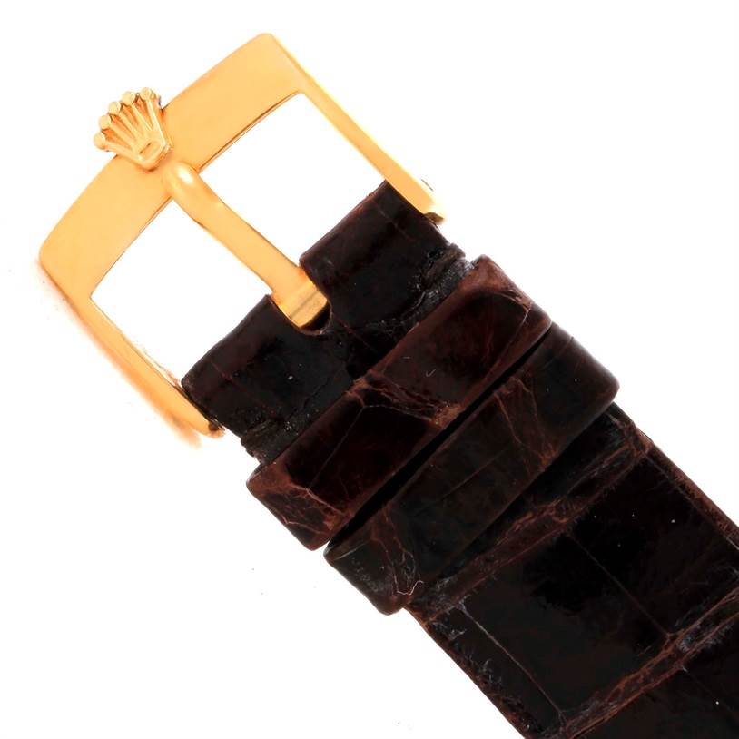 This image shows a close-up of the brown leather strap and the gold buckle of a Rolex Cellini 4127 Men
s Yellow Gold Champagne Dial 4127 Men
s Yellow Gold Champagne Dial watch.