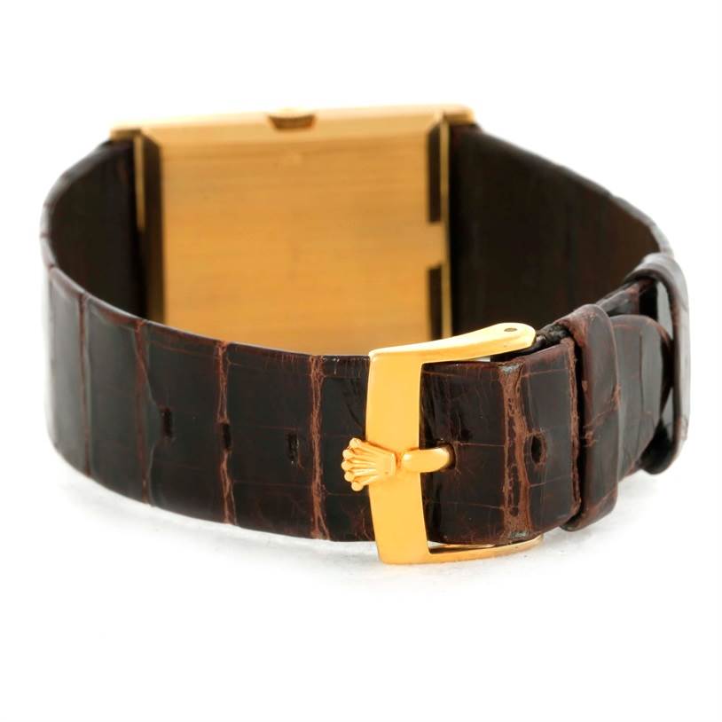 This Rolex Cellini 4127 Men
s Yellow Gold Champagne Dial 4127 Men
s Yellow Gold Champagne Dial watch is shown from an oblique rear angle, highlighting the brown leather strap and gold buckle.