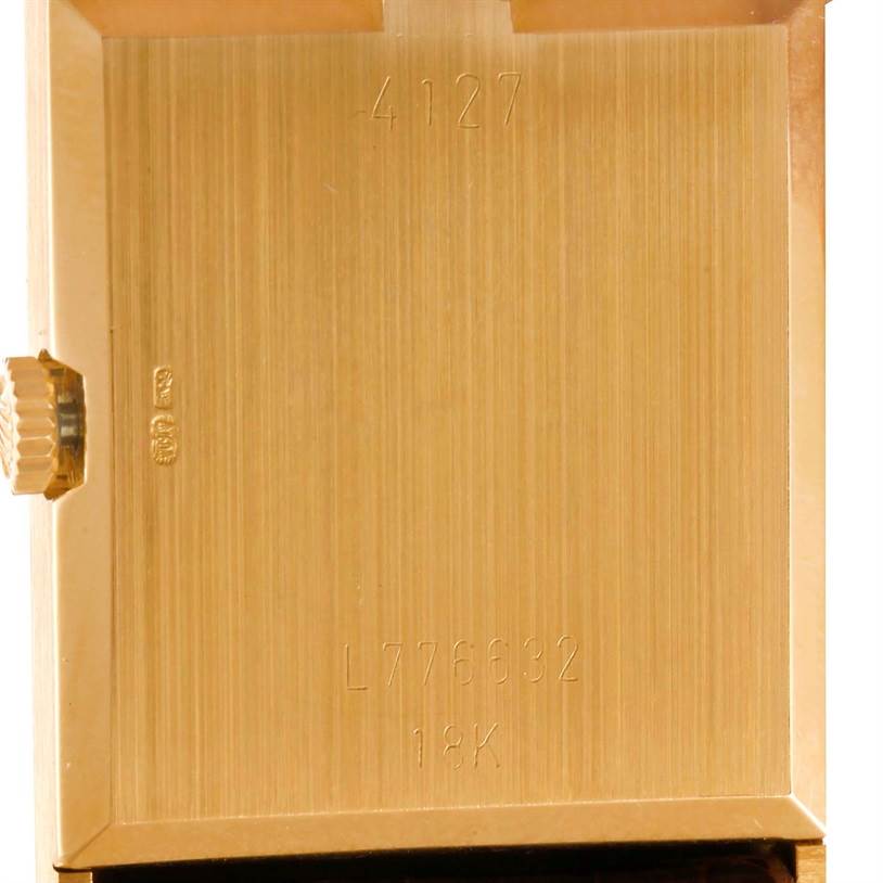 This image shows the back casing and crown of a Rolex Cellini 4127 Men
s Yellow Gold Champagne Dial 4127 Men
s Yellow Gold Champagne Dial watch, highlighting its serial number and 18K gold material.