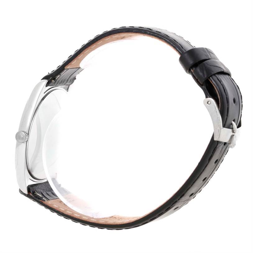 This Rolex Cellini 4233 Men's White Gold White Dial 4233 Men's White Gold White Dial watch is shown from a side view, displaying its case, crown, and black leather strap with buckle.