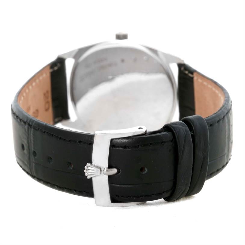 The image shows the back view of the Rolex Cellini 4233 Men's White Gold White Dial 4233 Men's White Gold White Dial watch, including its black leather strap and silver clasp.