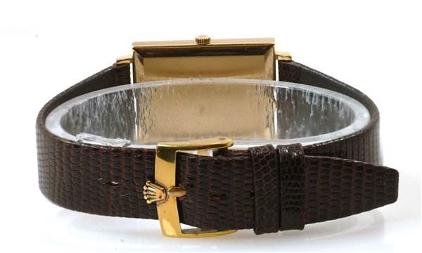 The image shows the back view of a Rolex Cellini 3607 Men's Yellow Gold Silver Dial 3607 Men's Yellow Gold Silver Dial watch with a brown leather strap and gold buckle.